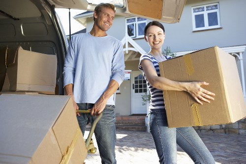 Movers carrying furniture through a narrow Haringey staircase